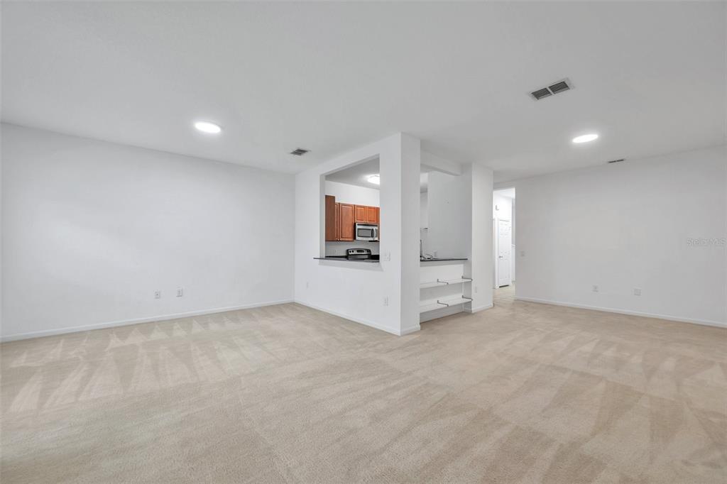 8206 Bally Money Road Tampa, FL 33610 - Photo 10 of 43 an empty room with a fireplace and windows