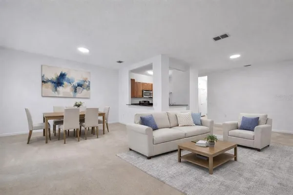 a living room with furniture a rug and a painting