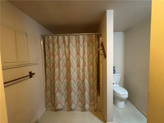 a white toilet sitting next to a small bathroom