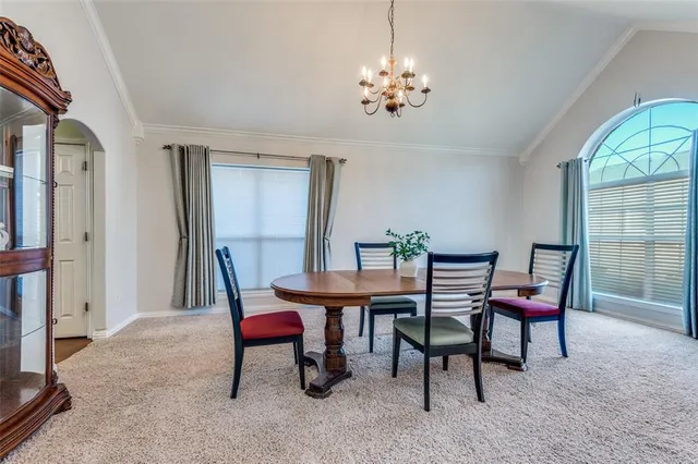 a view of a dining room with furniture and chandelier