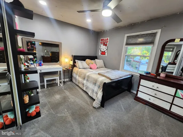 a bedroom with a bed furniture and a window