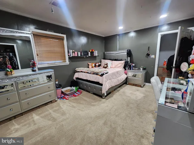 a spacious bedroom with a bed and a couch