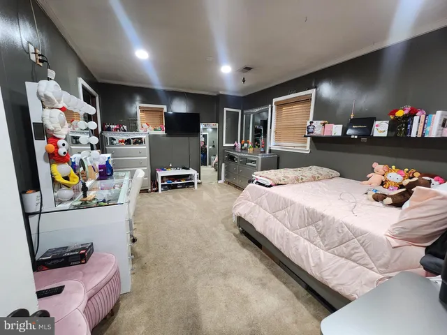 a bedroom with a bed furniture and a flat screen tv
