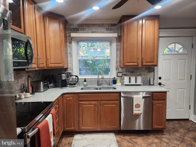 a kitchen with a sink stove top oven and cabinets