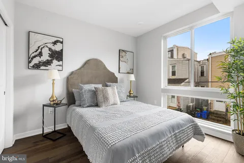 a bedroom with a bed and a lamp