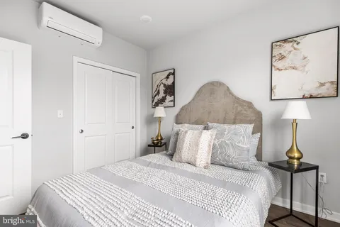 a bedroom with a large bed and a chandelier