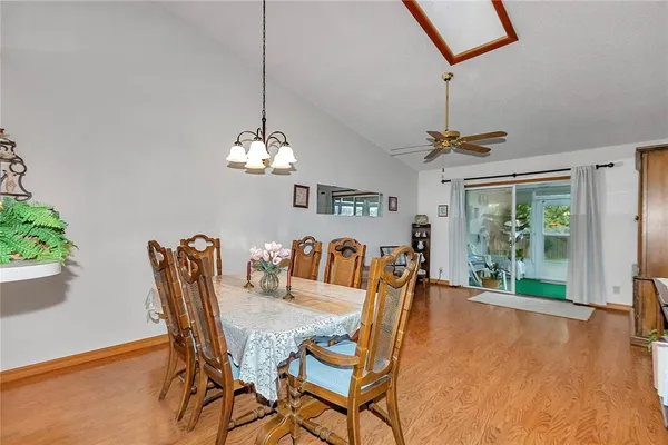 a dining room with furniture a chandelier and window
