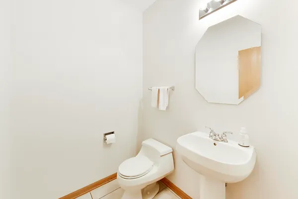 a bathroom with a sink a mirror and toilet
