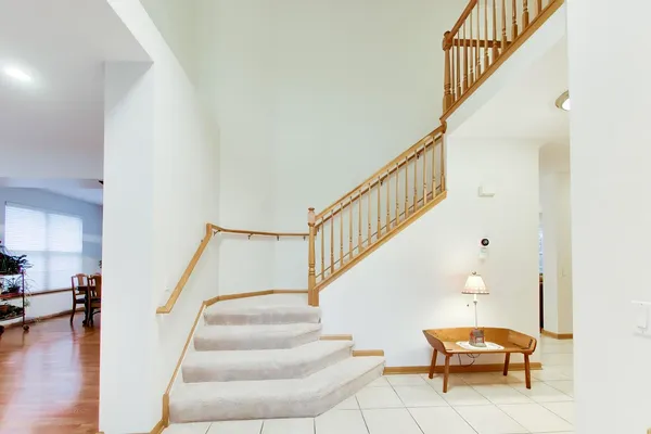 a living room with wooden floor and stairs