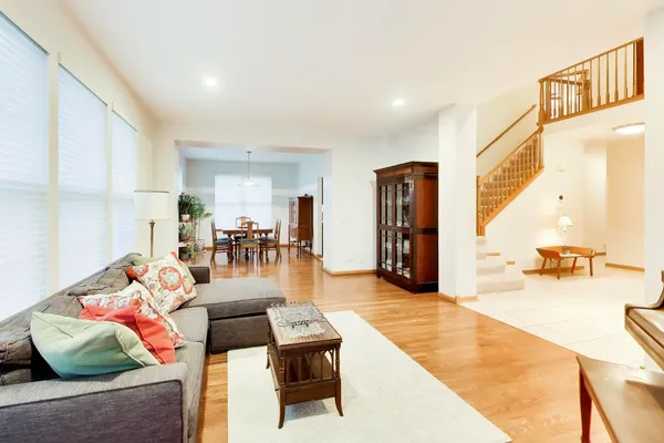 a living room with furniture and wooden floor