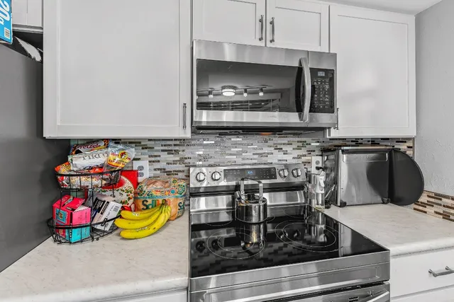 a kitchen with a stove and a microwave