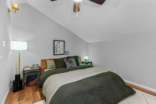 a bedroom with a bed and a lamp