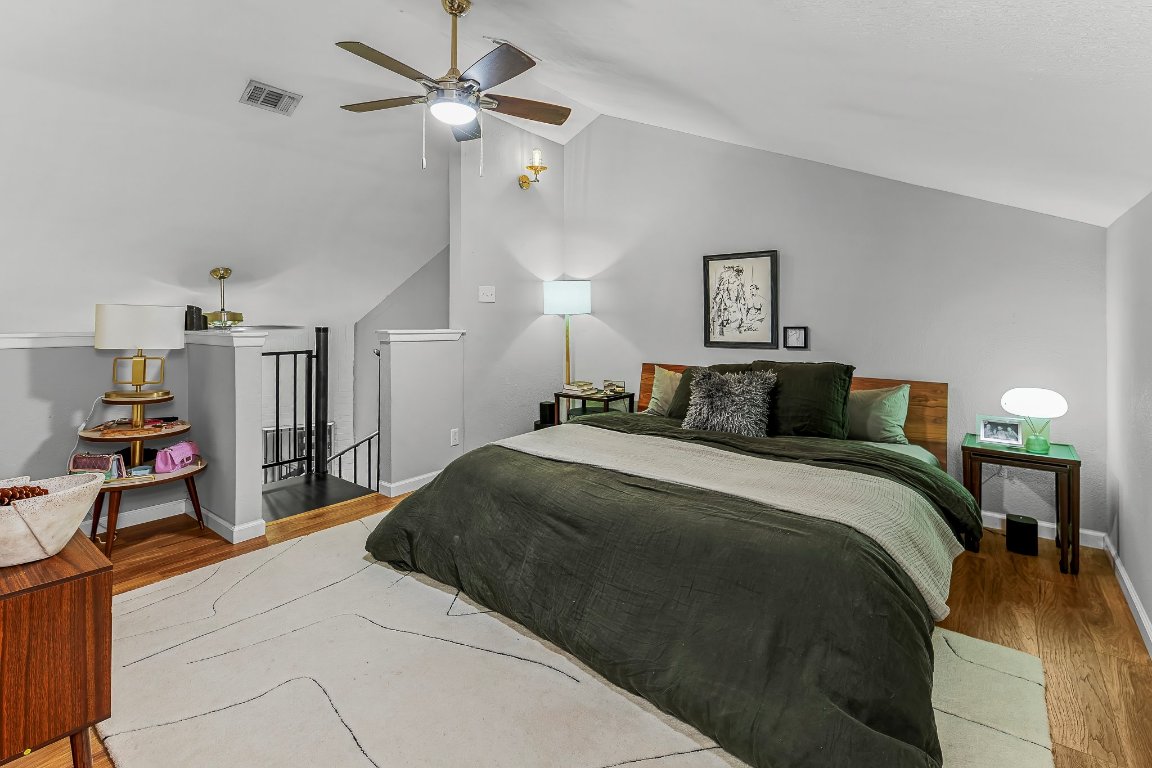 2500 Burleson Road, Unit 621 Austin, TX 78741 - Photo 19 of 26 a bedroom with a bed and a chandelier