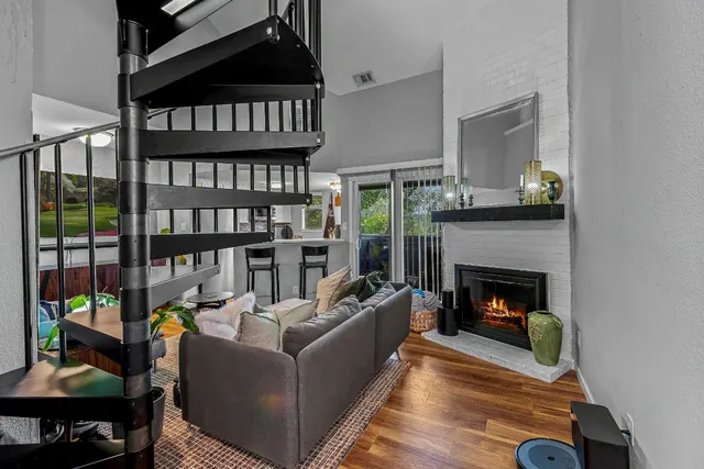 a living room with furniture a fireplace and a book shelf