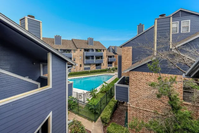 a aerial view of a house with a yard and balcony
