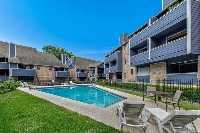 a view of a house with swimming pool and sitting area