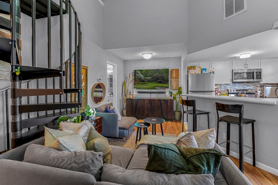 2500 Burleson Road, Unit 621 Austin, TX 78741 - Photo 3 of 26 a living room with furniture kitchen view and a flat screen tv