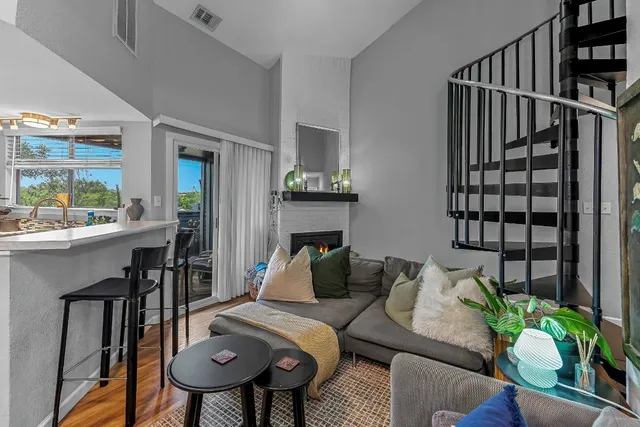 a living room with furniture and a potted plant