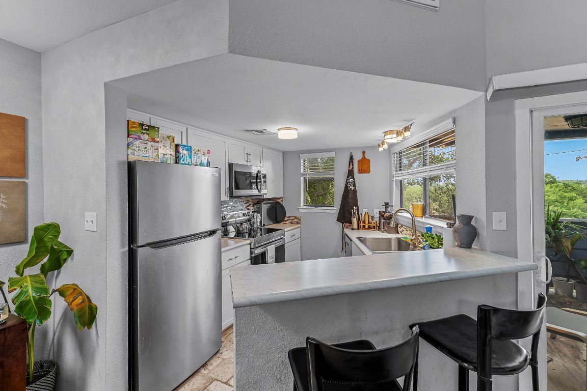 2500 Burleson Road, Unit 621 Austin, TX 78741 - Photo 6 of 26 a kitchen with refrigerator and table