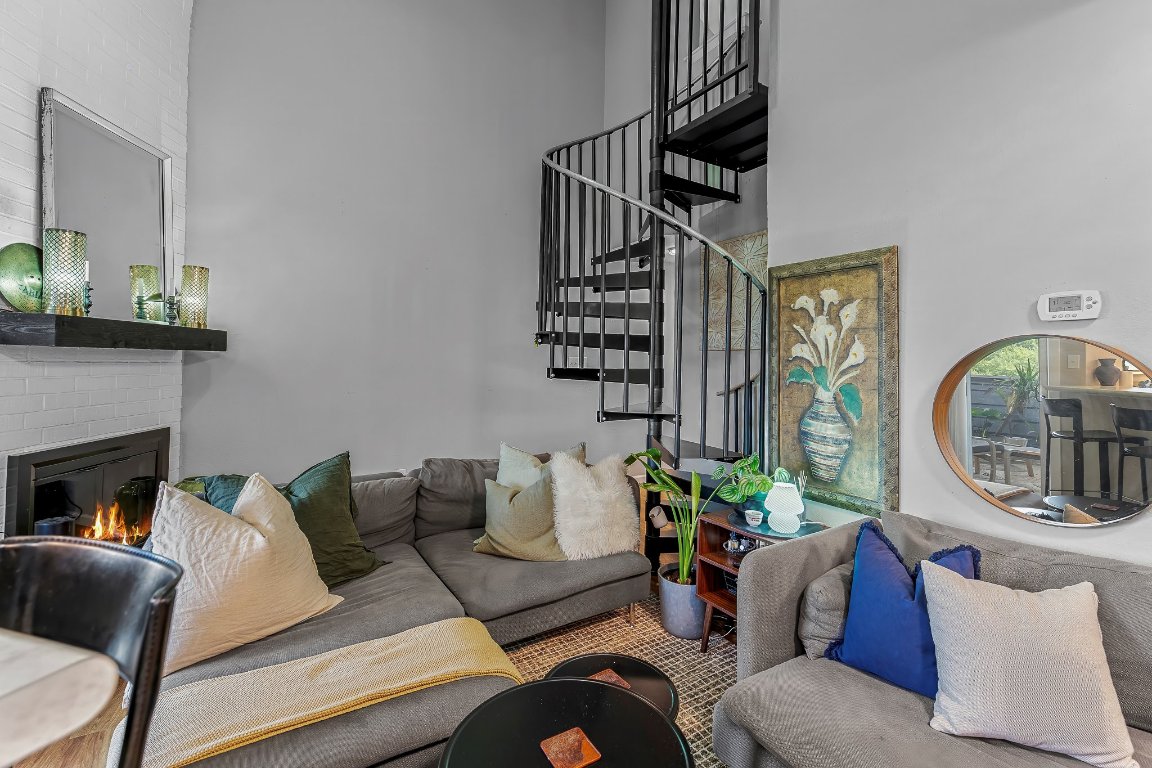 2500 Burleson Road, Unit 621 Austin, TX 78741 - Photo 7 of 26 a living room with furniture a fireplace and a potted plant