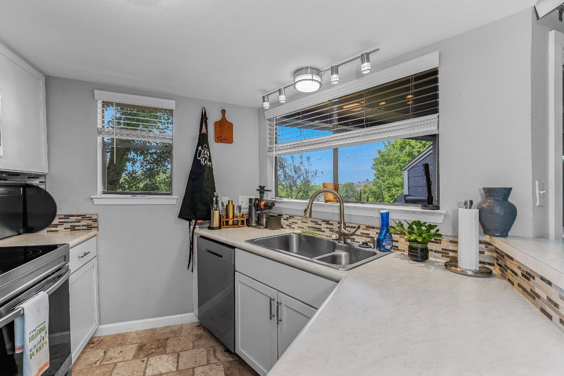 2500 Burleson Road, Unit 621 Austin, TX 78741 - Photo 8 of 26 a kitchen with sink refrigerator and window