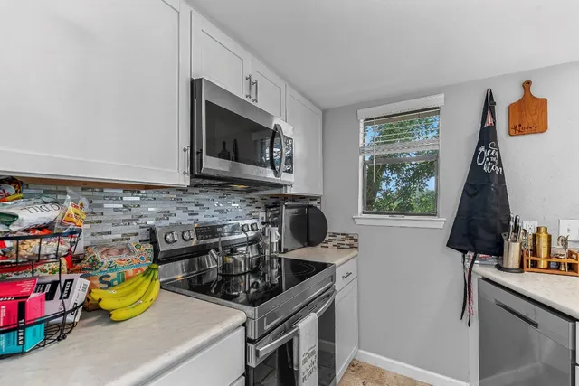 a kitchen with a stove a sink and a microwave