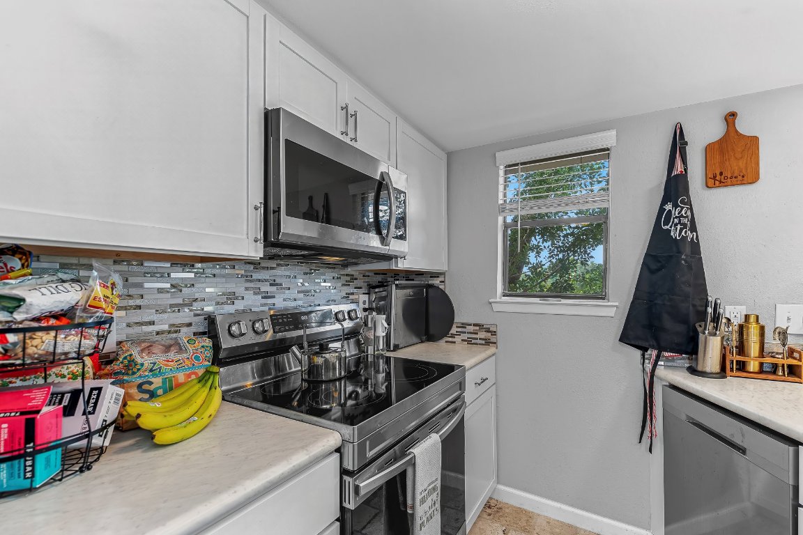 2500 Burleson Road, Unit 621 Austin, TX 78741 - Photo 9 of 26 a kitchen with a stove a sink and a microwave