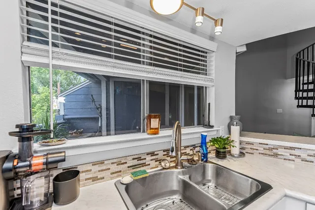 a kitchen with a sink and a stove top oven