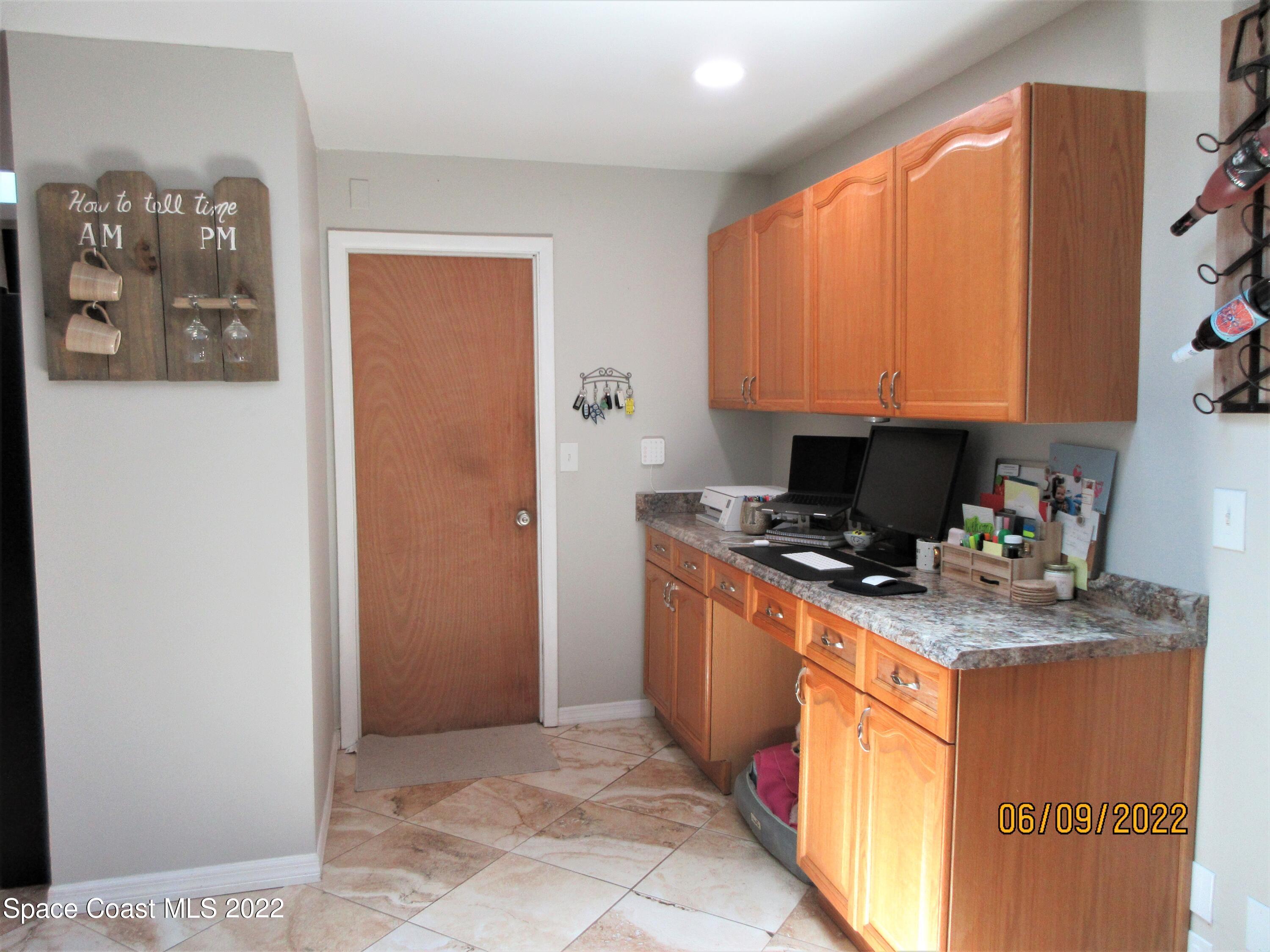 2547 Locksley Road Melbourne, FL 32935 - Photo 11 of 28 a kitchen with stainless steel appliances granite countertop a stove a sink and a refrigerator