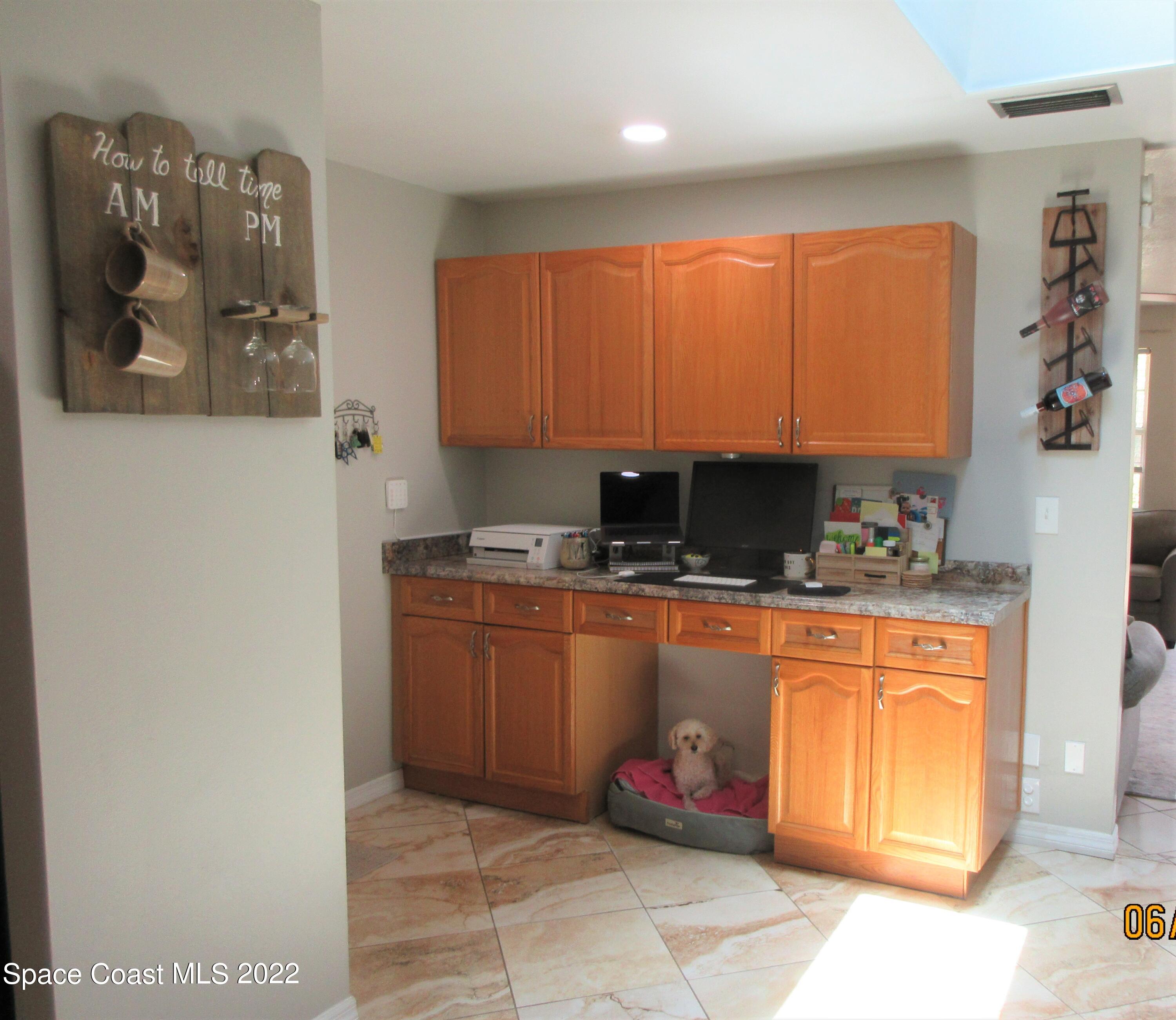 2547 Locksley Road Melbourne, FL 32935 - Photo 12 of 28 a kitchen with stainless steel appliances granite countertop a refrigerator sink and cabinets