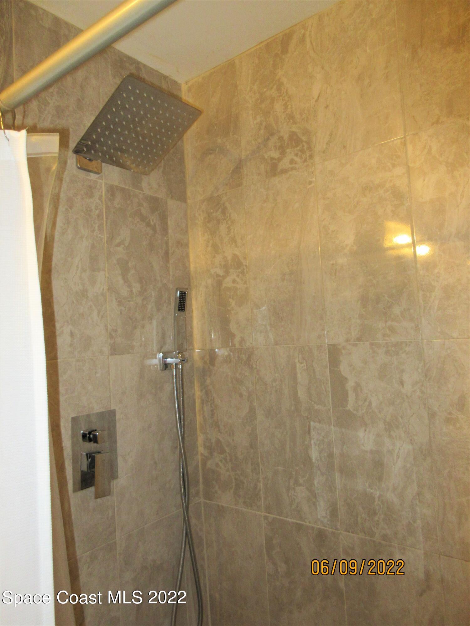 2547 Locksley Road Melbourne, FL 32935 - Photo 17 of 28 a bathroom with a shower