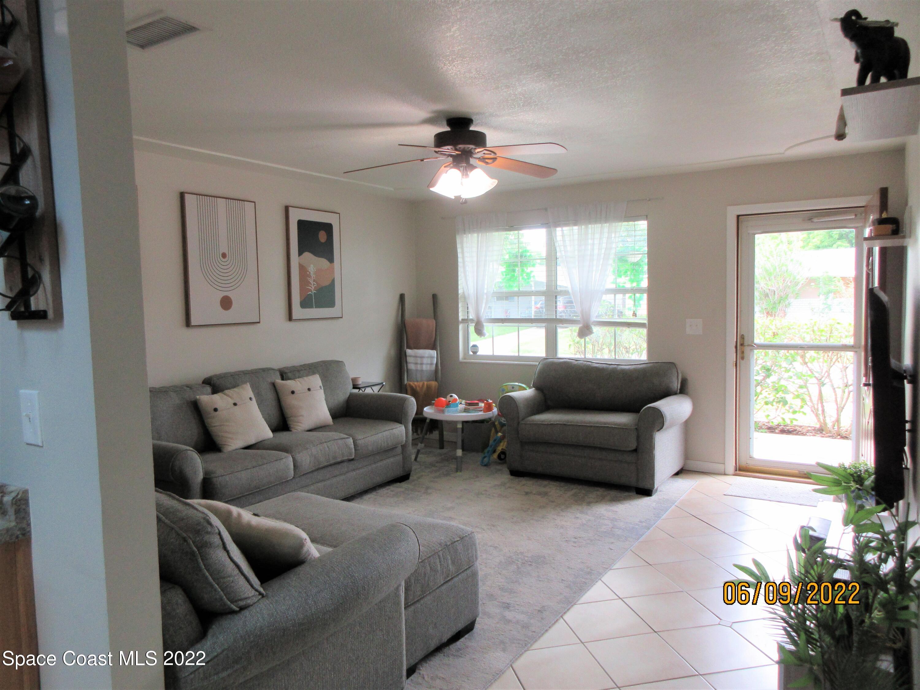 2547 Locksley Road Melbourne, FL 32935 - Photo 2 of 28 a living room with furniture and a large window