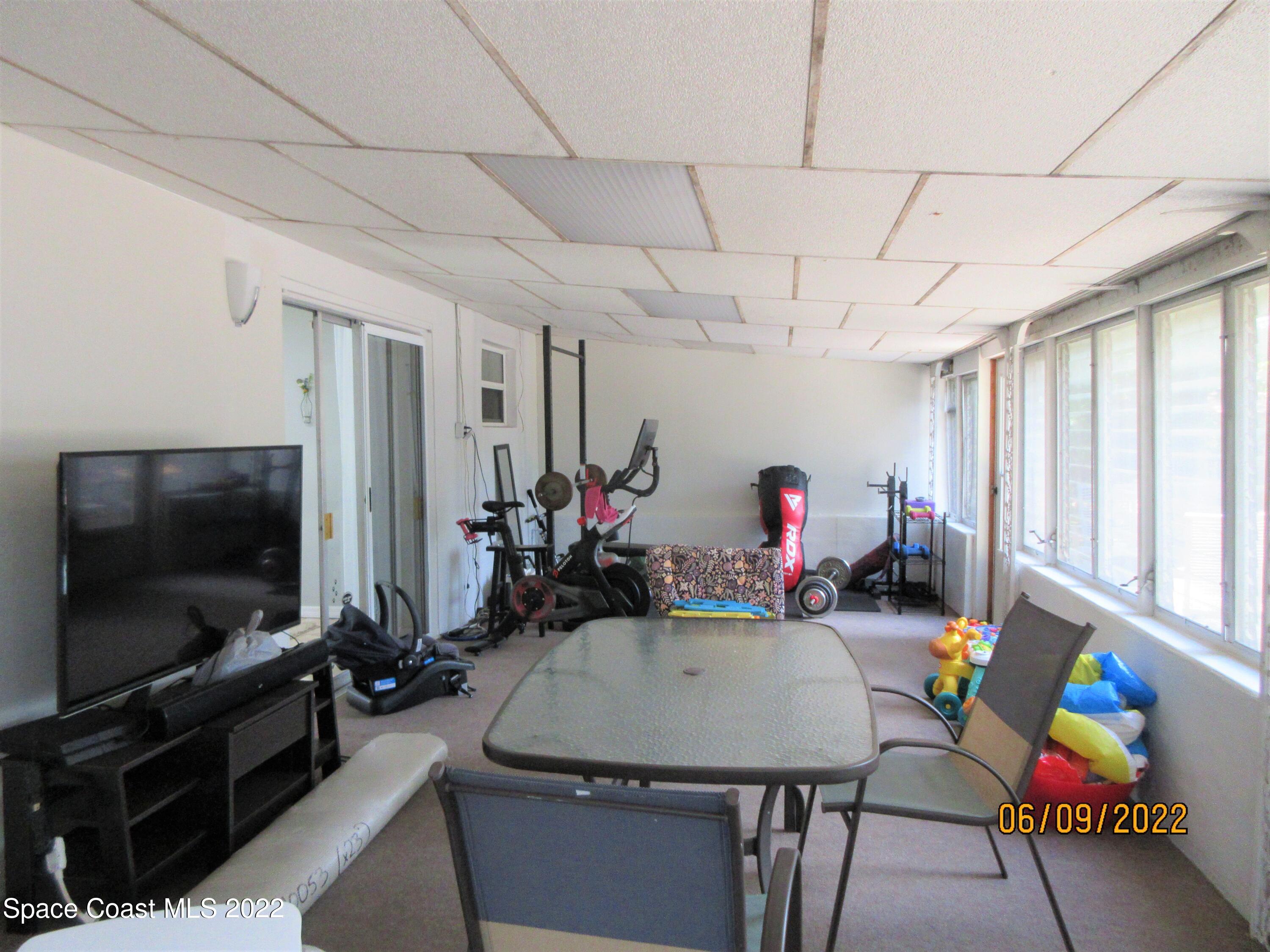 2547 Locksley Road Melbourne, FL 32935 - Photo 23 of 28 a living room with furniture and a flat screen tv