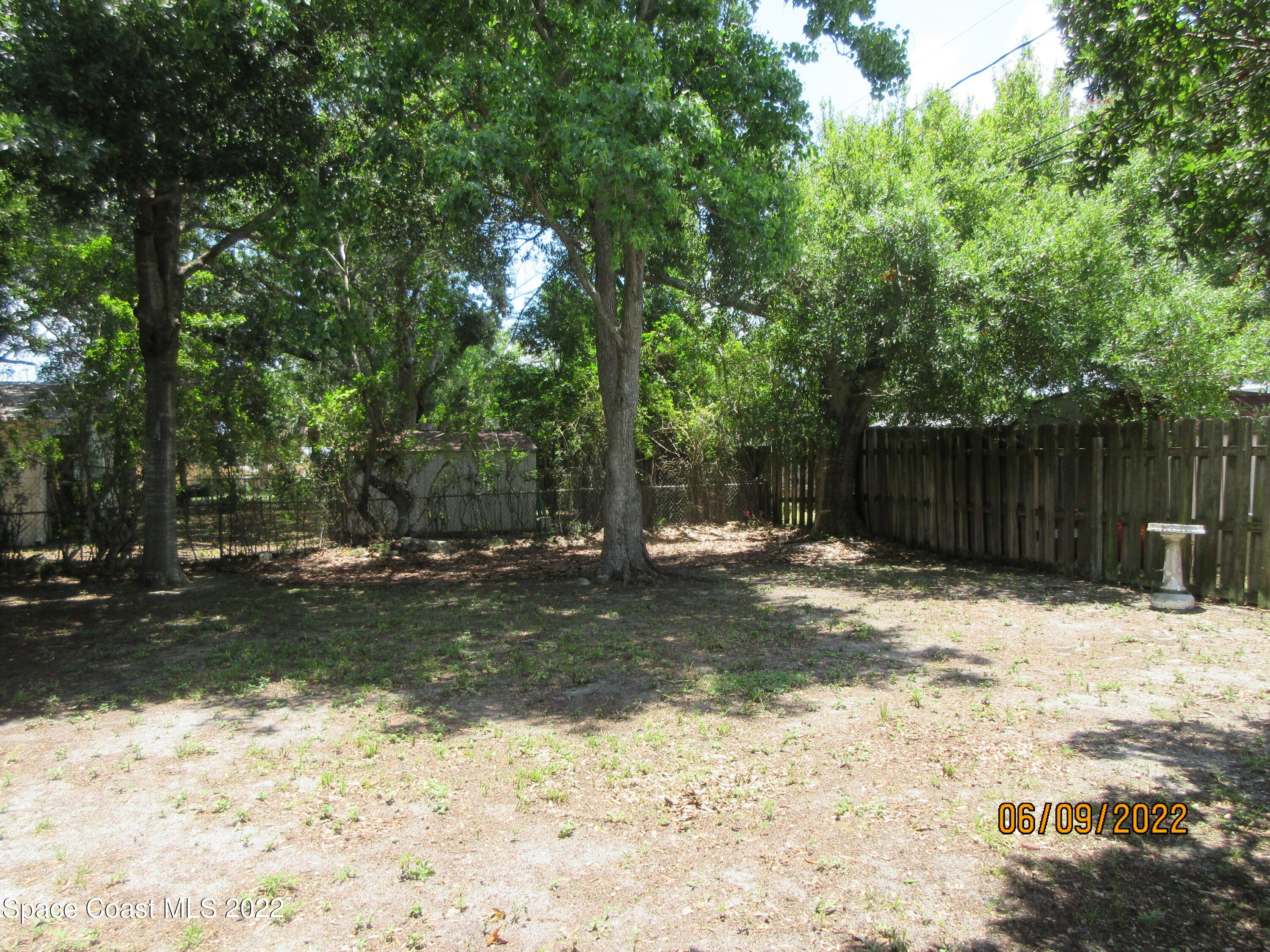 2547 Locksley Road Melbourne, FL 32935 - Photo 26 of 28 a backyard of a house with a tree