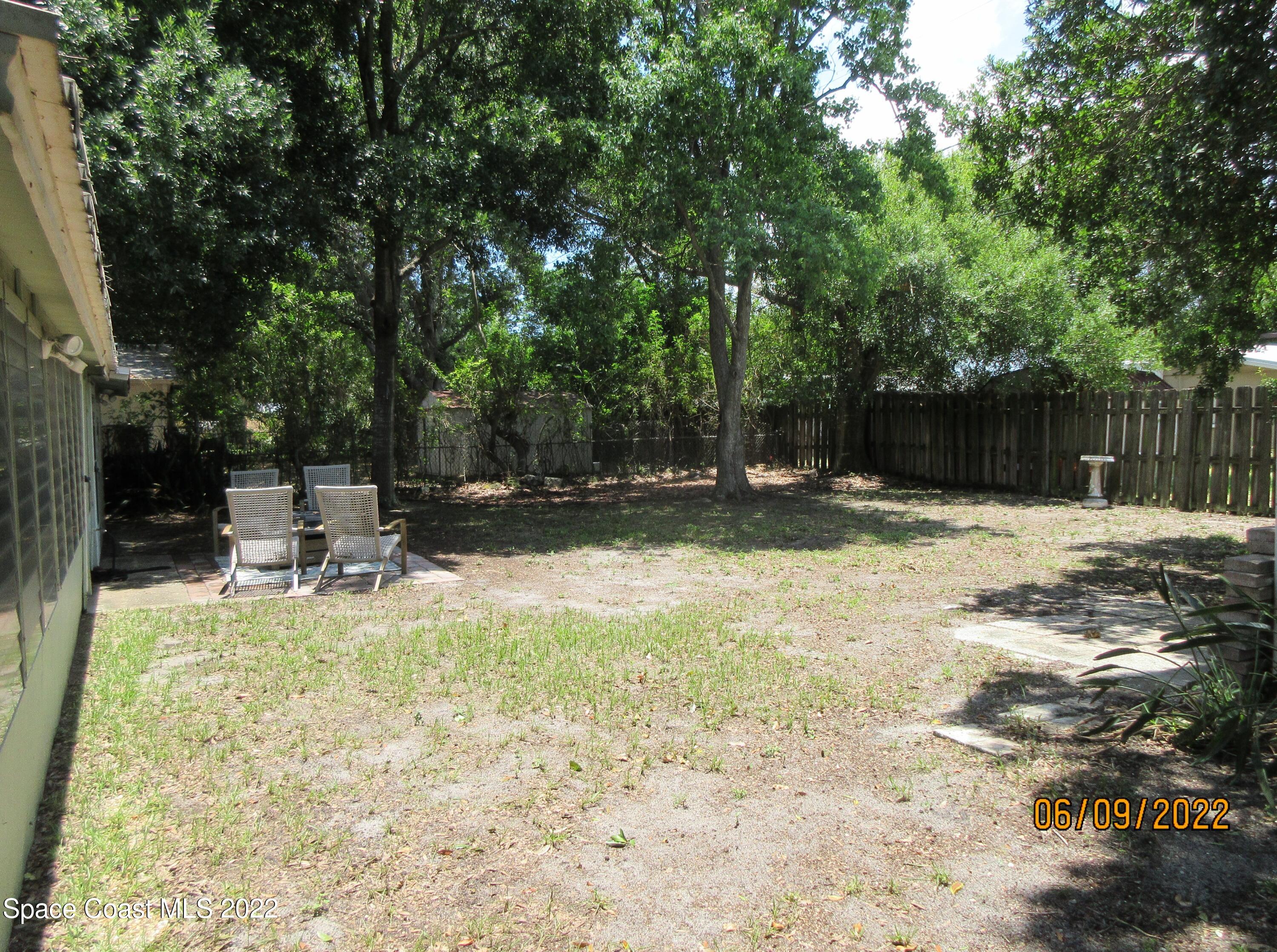 2547 Locksley Road Melbourne, FL 32935 - Photo 27 of 28 a view of swimming pool with a bench and trees
