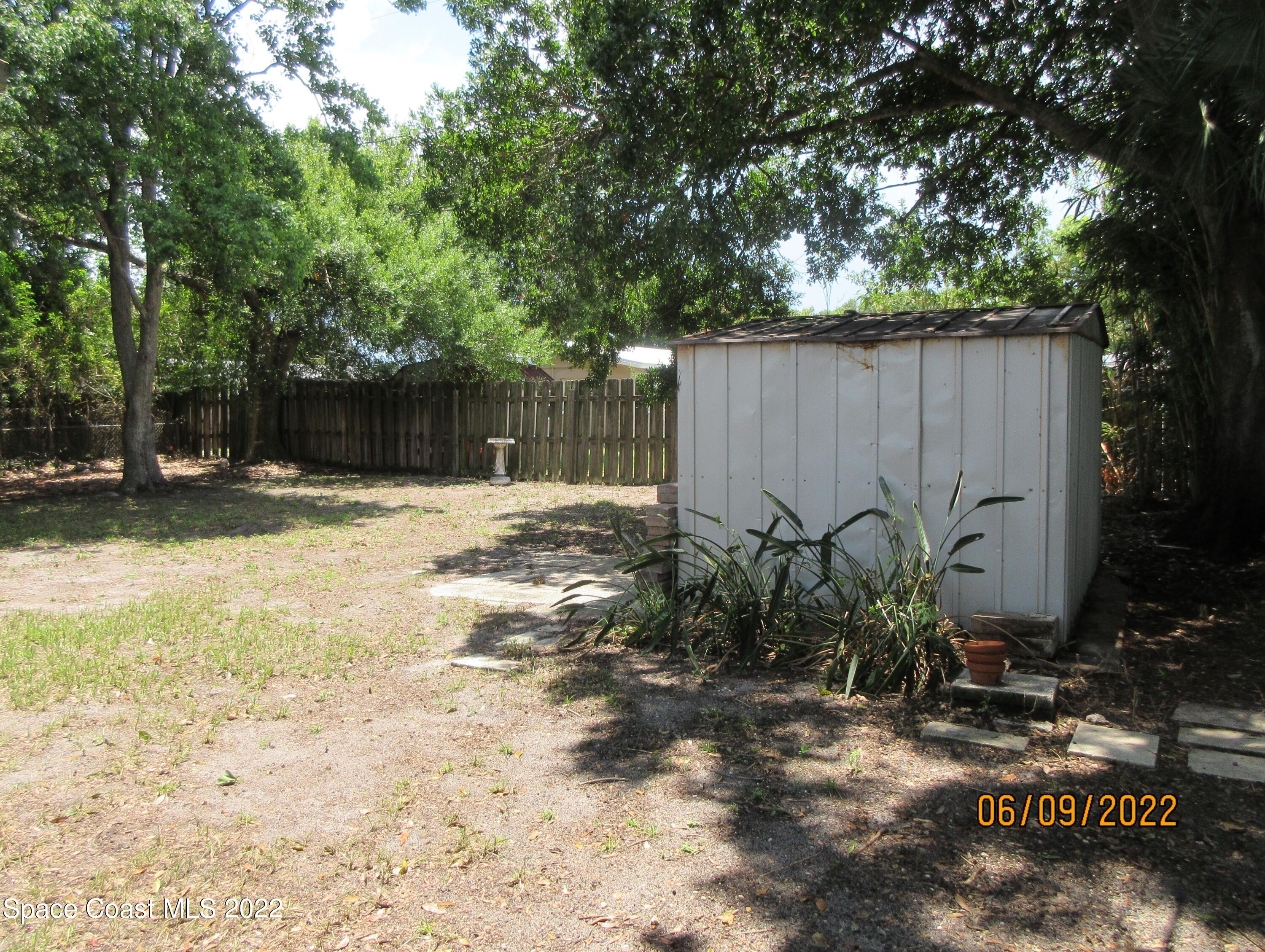 2547 Locksley Road Melbourne, FL 32935 - Photo 28 of 28 a backyard of a house with garden and trees