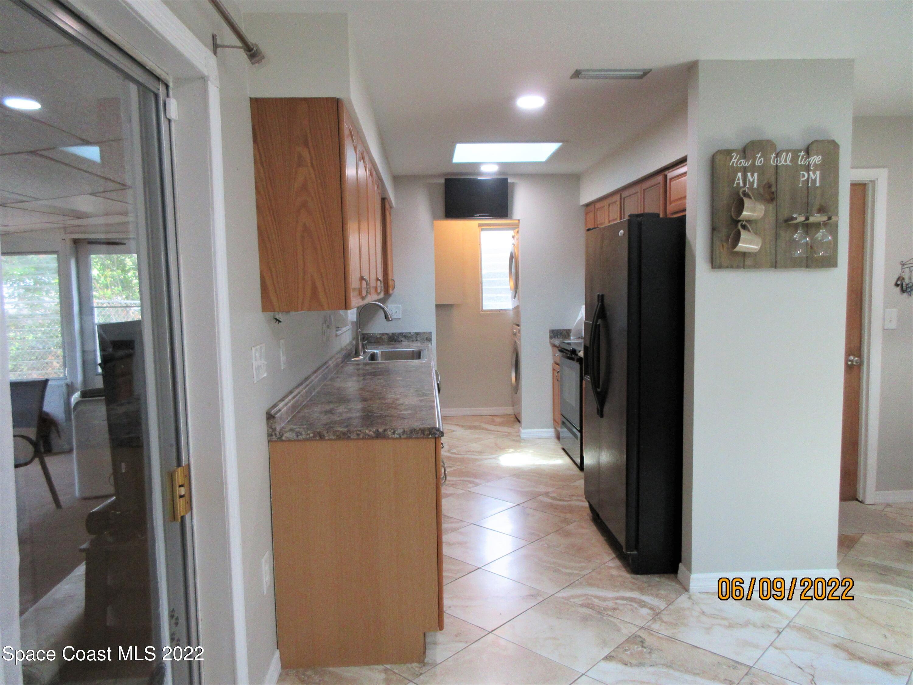 2547 Locksley Road Melbourne, FL 32935 - Photo 10 of 28 a kitchen with stainless steel appliances granite countertop a refrigerator and a sink