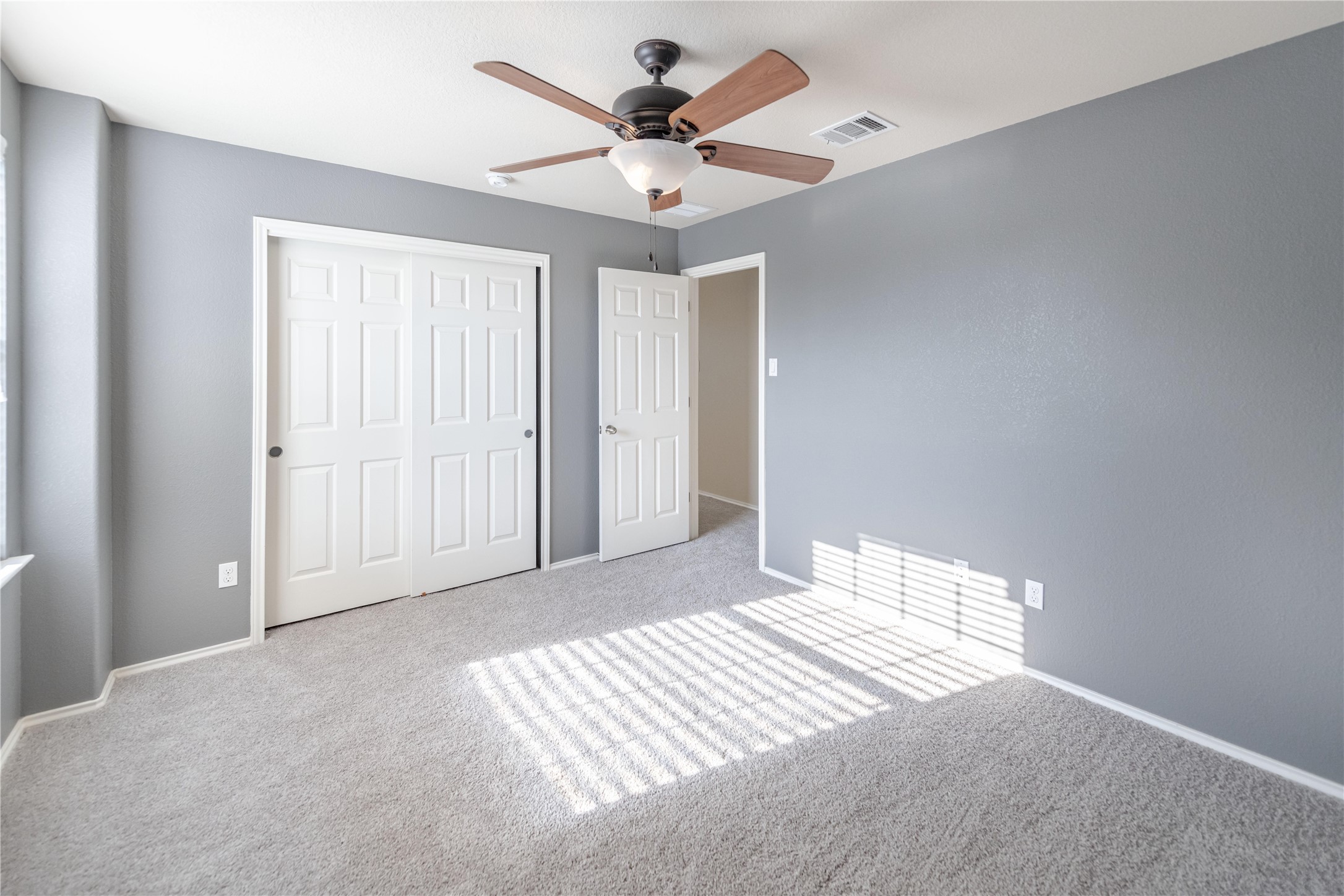 11221 Old Quarry Road Austin, TX 78717 - Photo 15 of 19 Natural light streams across soft carpeting and clean walls through a wide window.