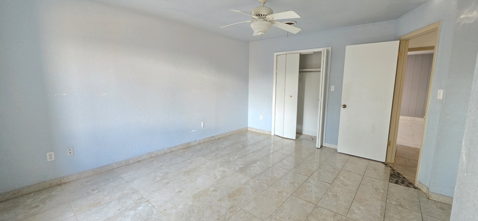 107903 South 4570 Road Sallisaw, OK 74955 - Photo 24 of 35 Spacious room featuring tile flooring, a ceiling fan, and multiple closet entries providing convenient storage access