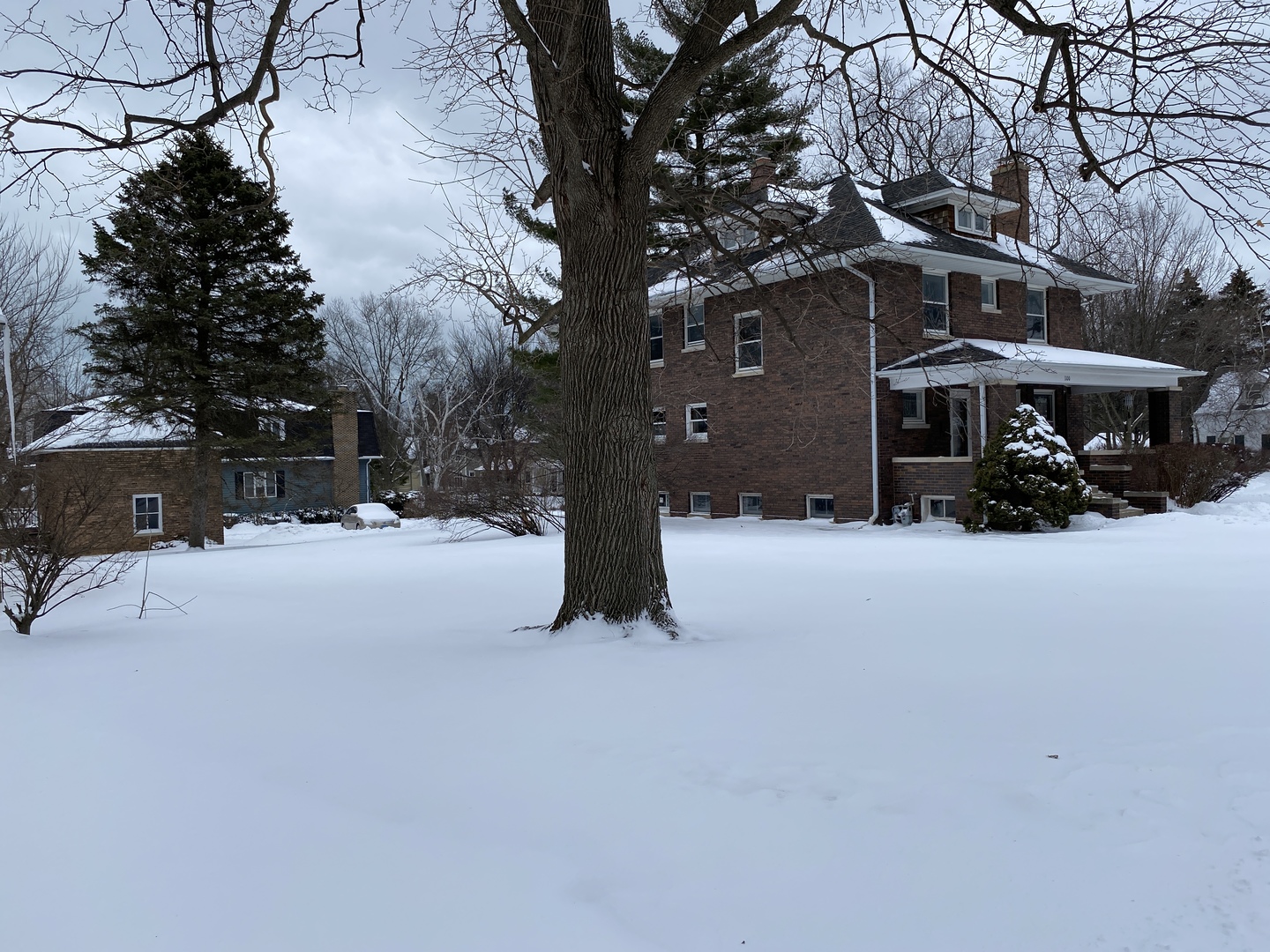 a tall house with trees in the background