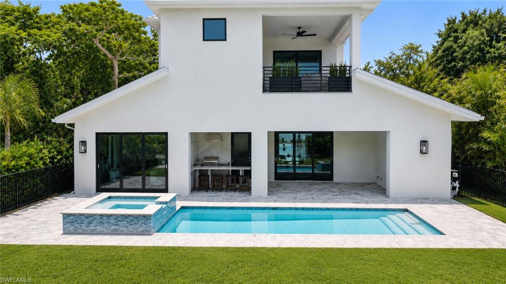 3028 Woodside Avenue Naples, FL 34112 - Photo 8 of 13 a view of house with backyard space and garden