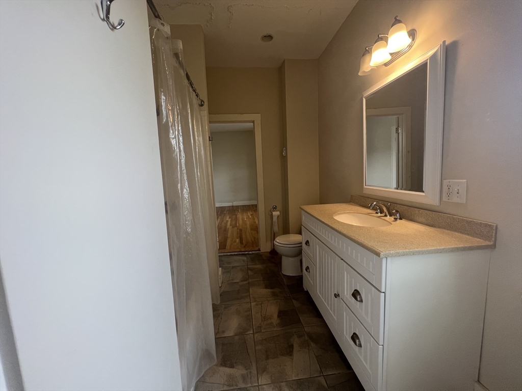 76 Chestnut Street, Unit 2 Newton, MA 02465 - Photo 11 of 21 a bathroom with a double vanity sink and mirror
