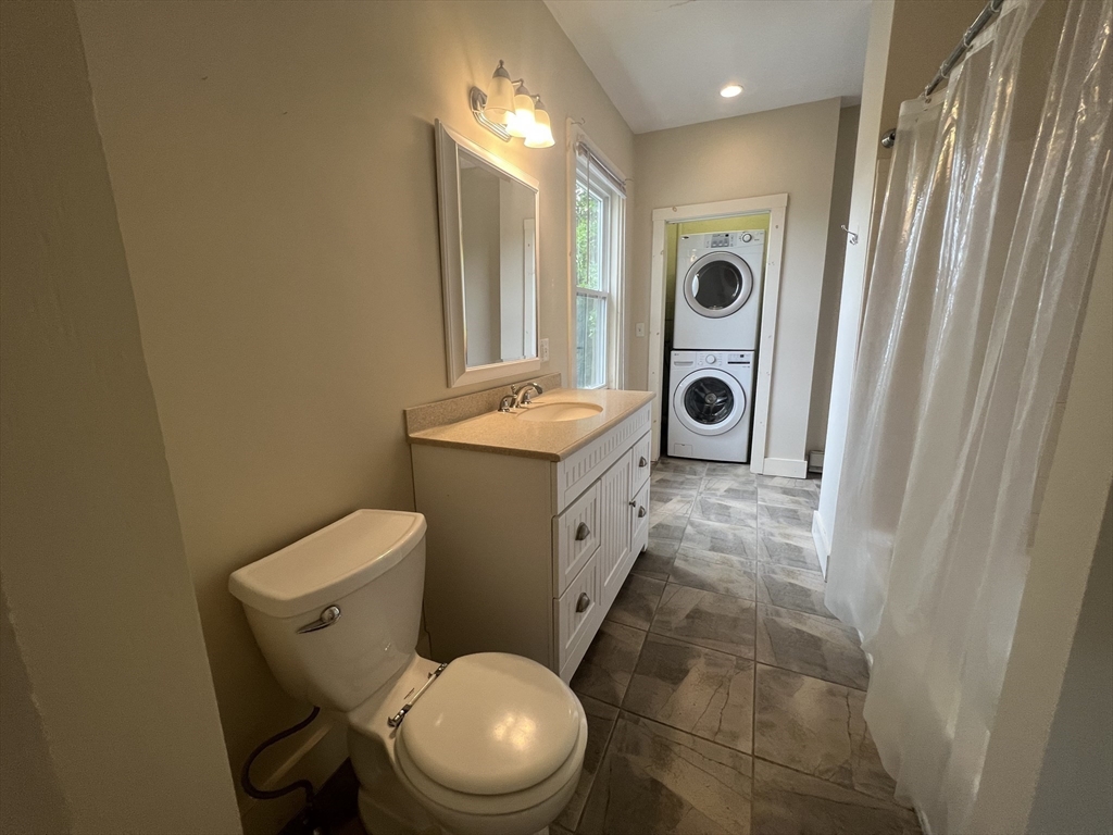 76 Chestnut Street, Unit 2 Newton, MA 02465 - Photo 12 of 21 a bathroom with a toilet a sink and a mirror