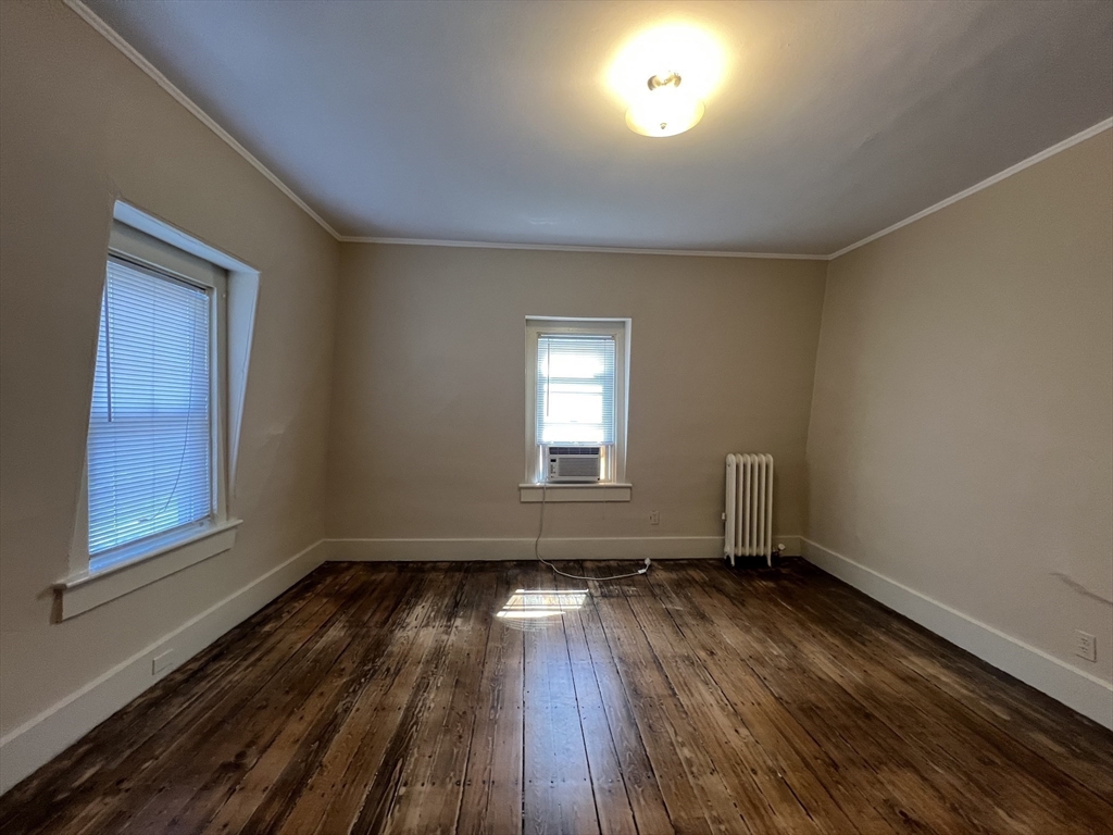 76 Chestnut Street, Unit 2 Newton, MA 02465 - Photo 16 of 21 a view of empty room with wooden floor and fan