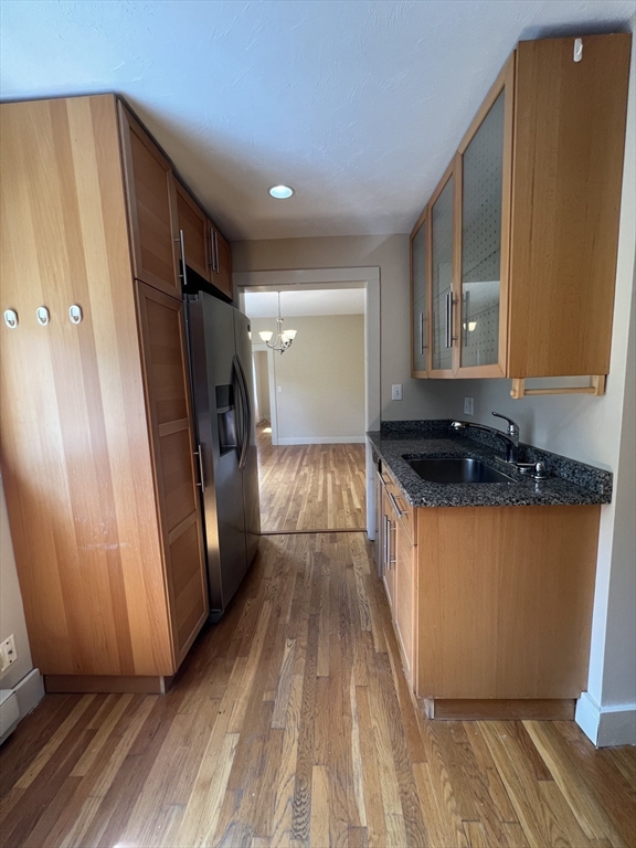 76 Chestnut Street, Unit 2 Newton, MA 02465 - Photo 5 of 21 a view of a refrigerator in kitchen and wooden floor