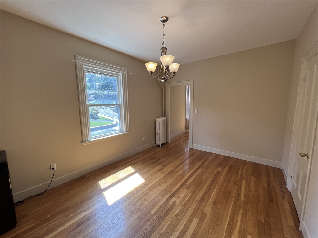 76 Chestnut Street, Unit 2 Newton, MA 02465 - Photo 7 of 21 a view of empty room with wooden floor and fan