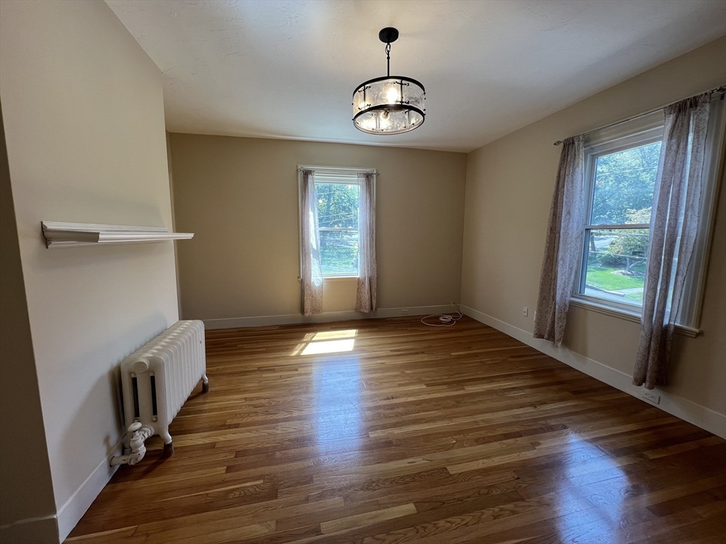 76 Chestnut Street, Unit 2 Newton, MA 02465 - Photo 8 of 21 a view of an empty room with wooden floor and a window