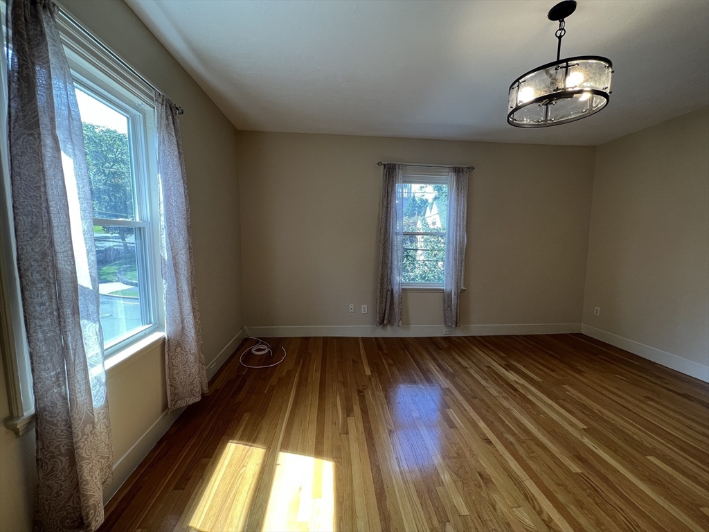 76 Chestnut Street, Unit 2 Newton, MA 02465 - Photo 9 of 21 a view of an empty room with wooden floor and a window