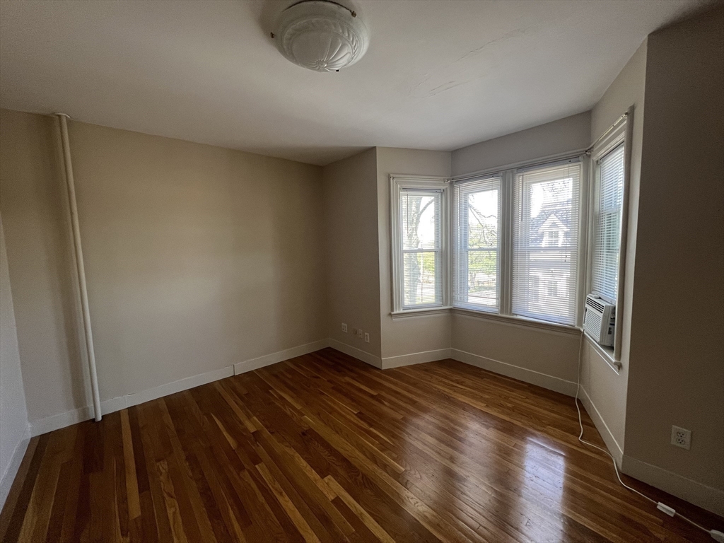 76 Chestnut Street, Unit 2 Newton, MA 02465 - Photo 10 of 21 a view of an empty room with wooden floor and a window