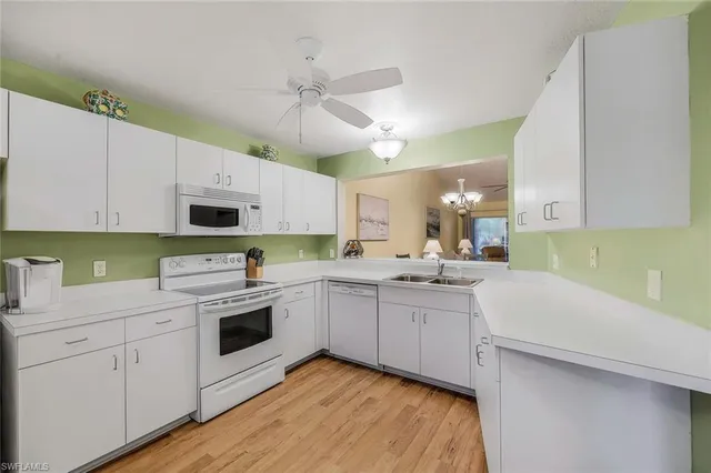 a kitchen with a sink a stove and cabinets